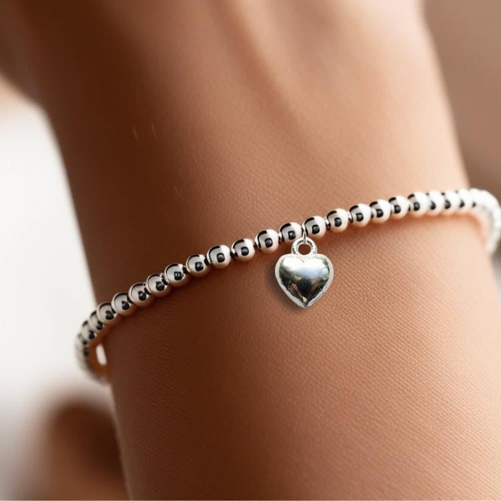 Silver beaded stretch bracelet with a chunky silver heart charm