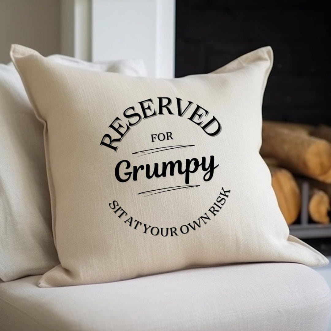 Cream linen-look cushion with the message Reserved For Grumpy - Sit at your own risk