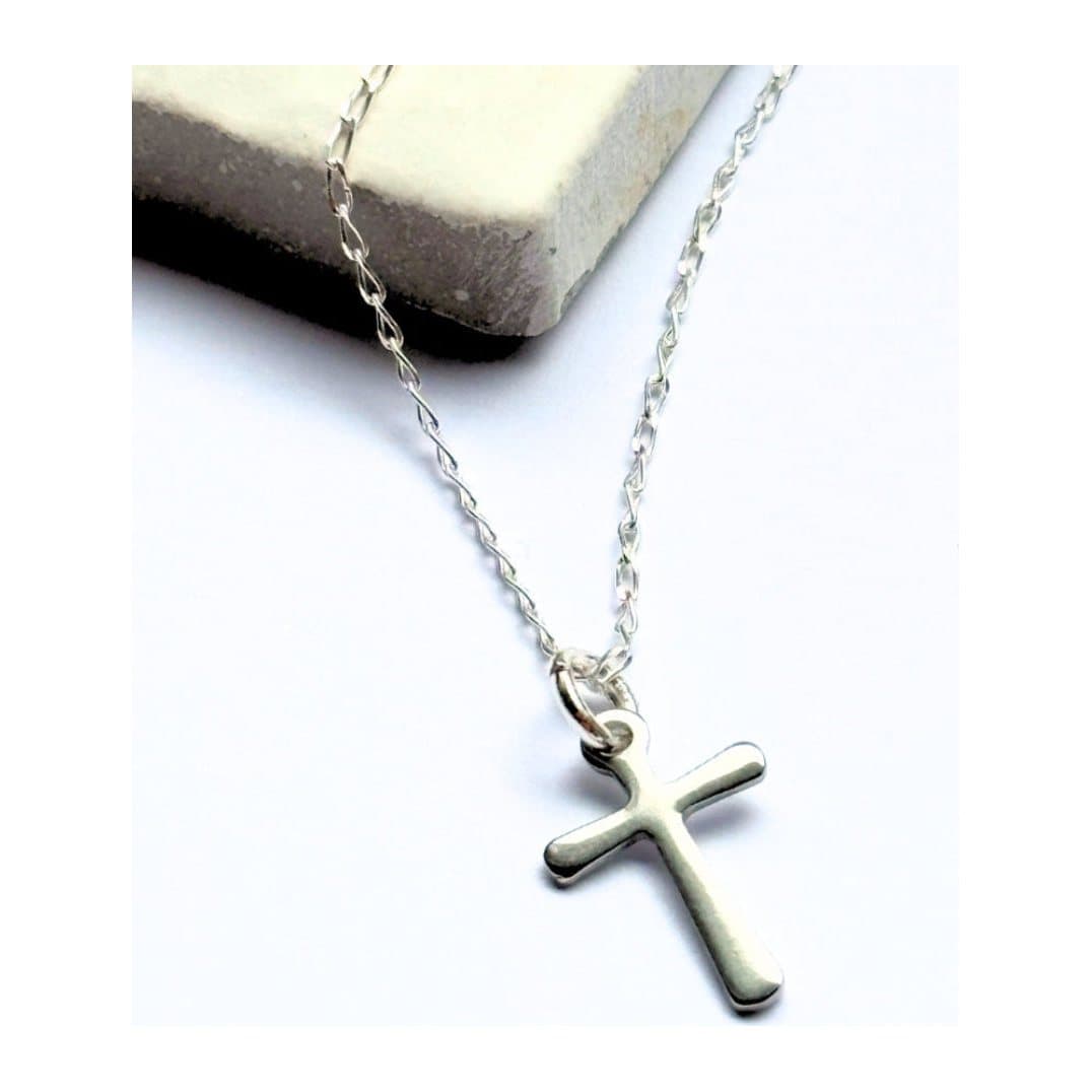 Silver cross charm necklace on a fine chain