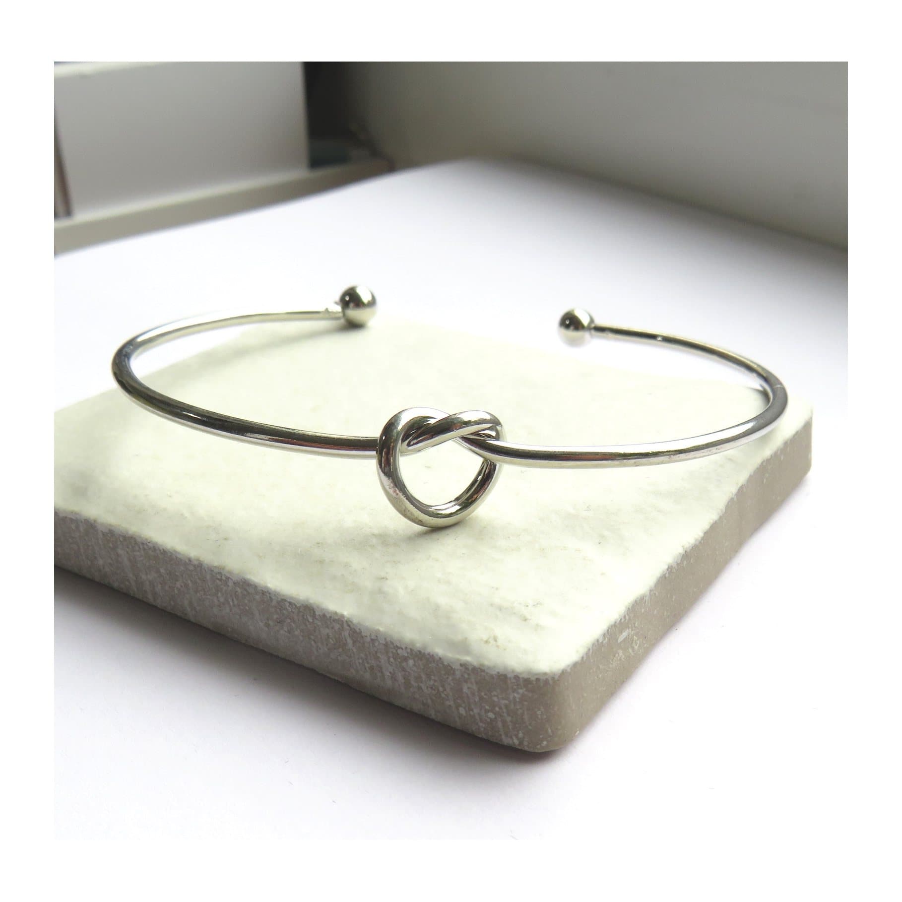 Silver knot bangle, a slim silver plated bangle with a knot design
