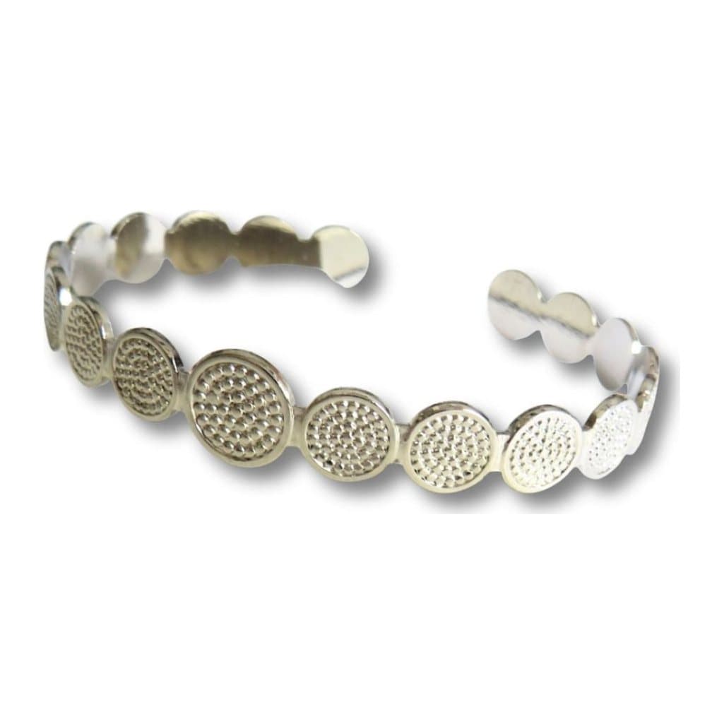 Silver textured circle bangle on a plain background