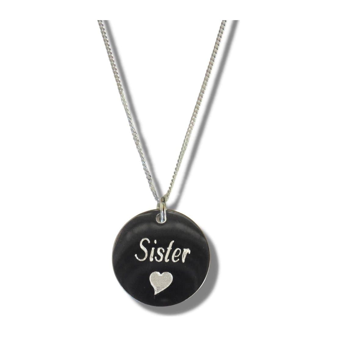 Silver round disc necklace engraved with the word Sister and a small heart on a fine chain