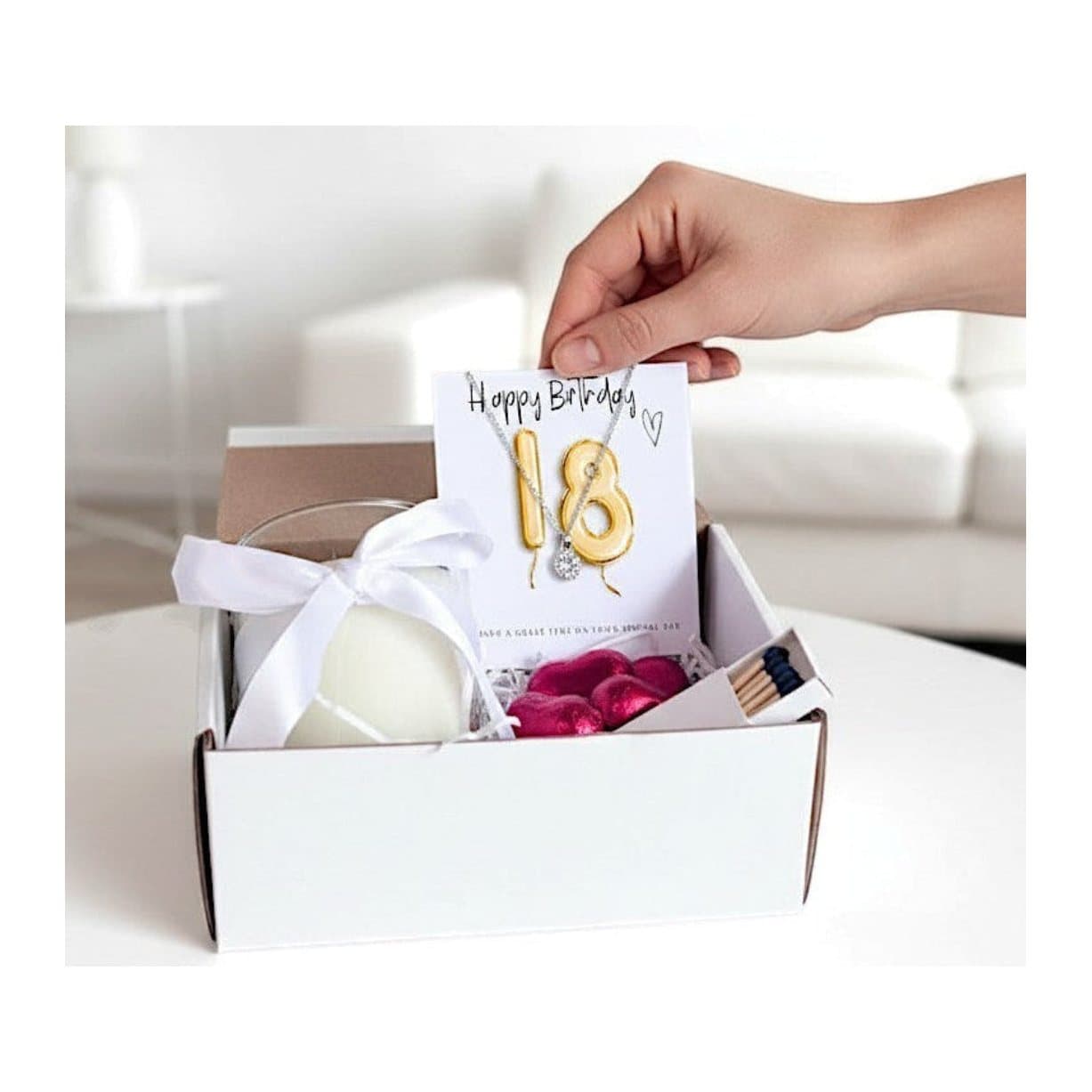 Small 18th birthday gold balloon hamper with a silver necklace, candle and chocolates