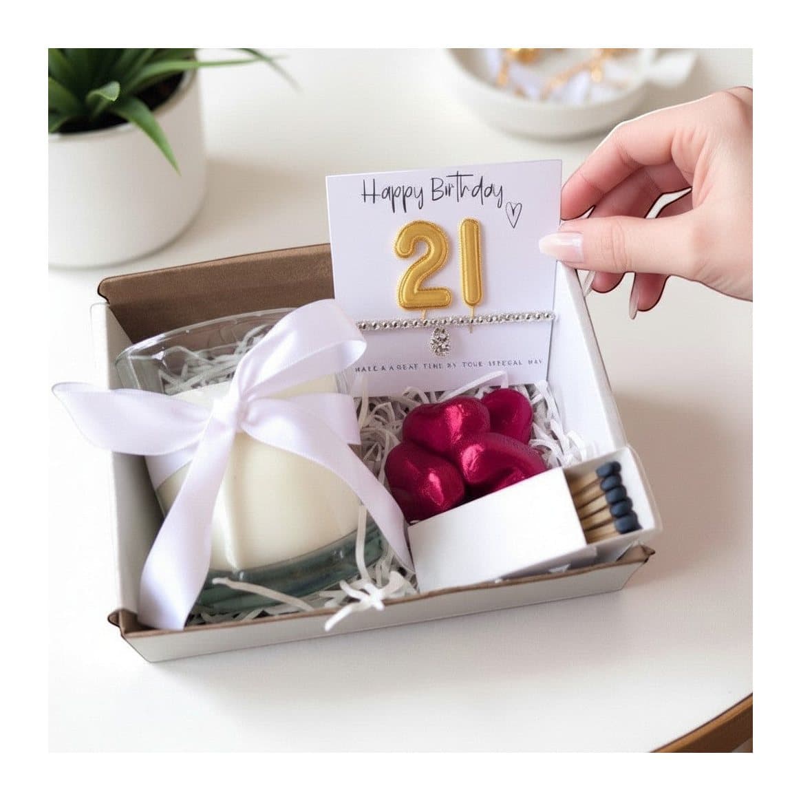 21st birthday gold balloons hamper with a bracelet, vanilla candle and chocolate hearts
