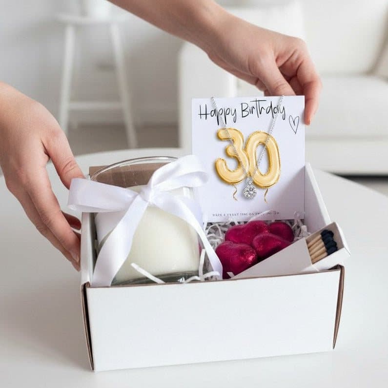 30th birthday hamper with a necklace, vanilla candle and red foiled chocolate hearts