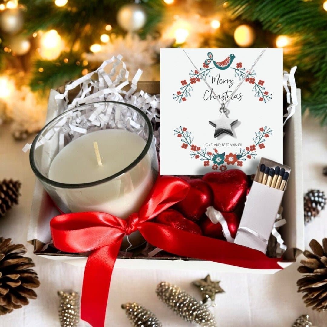 Christmas hamper with a star charm necklace, a vanilla candle and four chocolate hearts