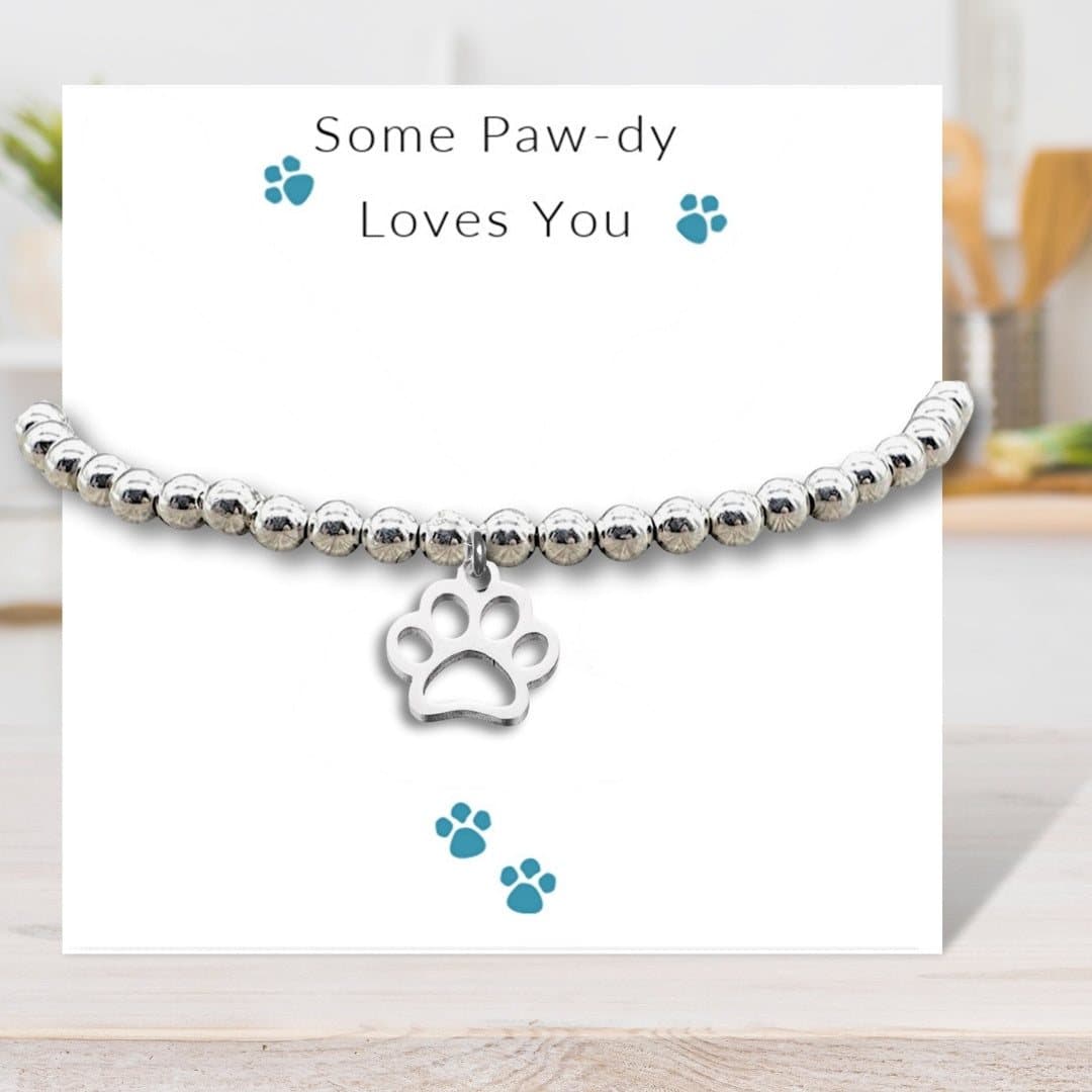 Silver beaded paw print charm bracelet with a Some Paw-dy Loves You message card