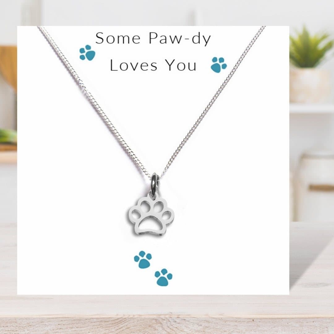 Paw print necklace on a chain with a 'Some Paw-dy Loves You' message card