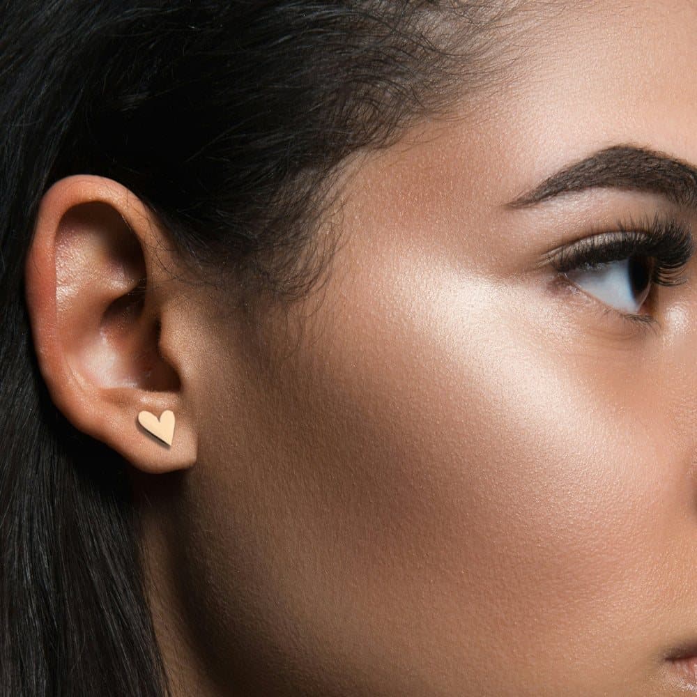 Tilted heart gold stud earrings in gold plated stainless steel